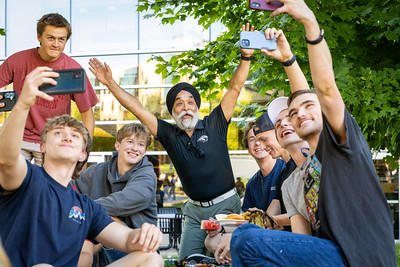 Chancellor Singh with students on the lawn.