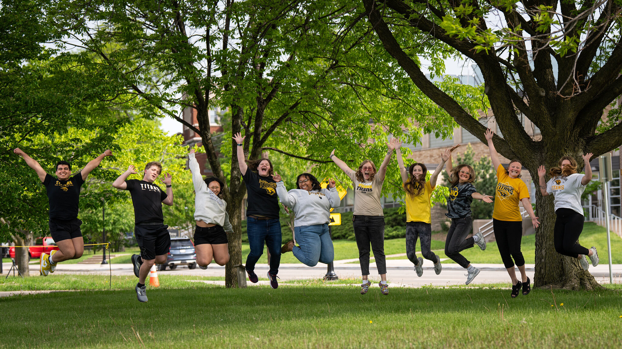 Tour guide team jumping in the air excitedly
