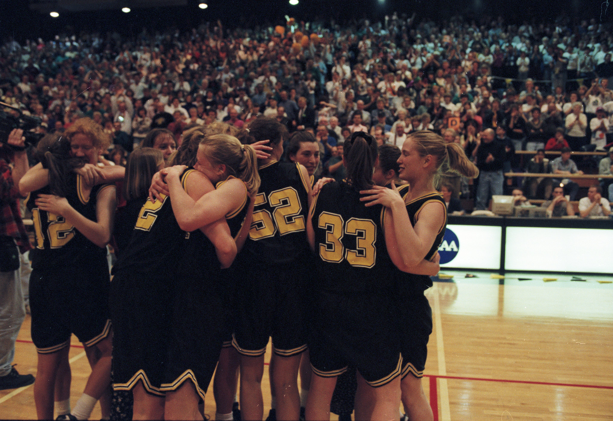 The UW-Oshkosh women's basketball team celebrates their national championship win at the 1996 NCAA Division III Women's Basketball Tournament