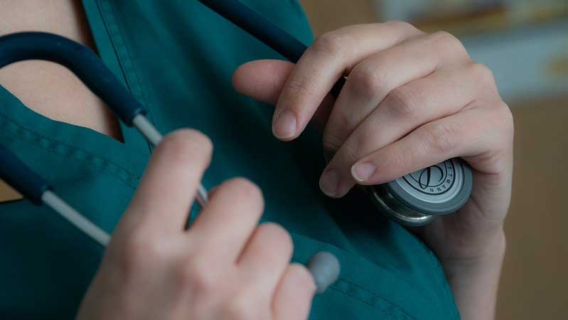 Medical professional wearing stethoscope around neck